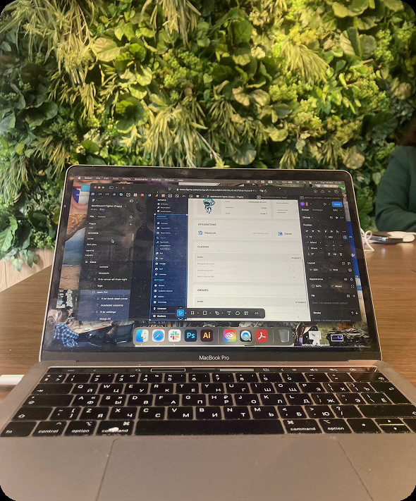 Photo of working space in web design studio with ui/ux on the screen